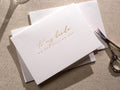 May include: A white card with gold foil lettering that reads "to my bride on our wedding day".
